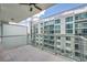 Spacious balcony features glass railings and a view of an adjacent high-rise at 111 N 12Th St # 1614, Tampa, FL 33602