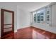 This cozy bedroom has hardwood floors, a door, and a large window allowing plenty of natural light to fill the space at 111 N 12Th St # 1614, Tampa, FL 33602