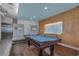Billiards table in the game room with seating and wood paneling at 111 N 12Th St # 1614, Tampa, FL 33602