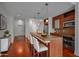 Well-lit kitchen features bar seating, modern appliances, and rich hardwood floors in a staged modern condo at 111 N 12Th St # 1614, Tampa, FL 33602