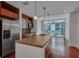 Modern kitchen with stainless steel appliances, island with sink and a sliding door to the balcony at 111 N 12Th St # 1614, Tampa, FL 33602