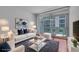 Bright living room with stylish furniture and a balcony offering city views at 111 N 12Th St # 1614, Tampa, FL 33602