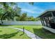 Beautiful backyard with a stone path and a screened porch, creating a perfect blend of comfort and nature at 125 Siobhan Ave, Tampa, FL 33613