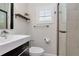 Updated bathroom with modern fixtures, white vanity, shower with glass door, and plantation shutters at 125 Siobhan Ave, Tampa, FL 33613