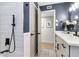 Modern bathroom featuring an open doorway, dark blue walls, and grey tile floors at 125 Siobhan Ave, Tampa, FL 33613