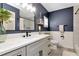 Bathroom featuring a white vanity with quartz countertops, modern fixtures, and blue accent wall at 125 Siobhan Ave, Tampa, FL 33613