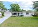Charming single-story home with a well-manicured lawn, white exterior, and lovely curb appeal at 125 Siobhan Ave, Tampa, FL 33613