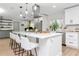Modern kitchen featuring white cabinets, stainless steel appliances, and a large island with breakfast bar seating at 125 Siobhan Ave, Tampa, FL 33613