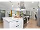 Open kitchen boasts stainless steel appliances, double oven, and center island with white countertops and cabinets at 125 Siobhan Ave, Tampa, FL 33613