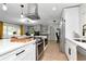 Open concept kitchen with stainless steel appliances, white countertops and cabinets, and breakfast bar seating at 125 Siobhan Ave, Tampa, FL 33613
