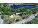 Aerial shot of a lakefront home with a long driveway, RV parking, and mature tree coverage at 13329 N Armenia Ave, Tampa, FL 33613