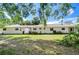 Expansive backyard of the home showing the lawn, exterior windows, and neutral color scheme at 13329 N Armenia Ave, Tampa, FL 33613