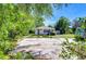 Cozy home featuring a spacious concrete parking area and lush green surroundings at 13329 N Armenia Ave, Tampa, FL 33613