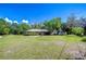 Well-maintained home with a spacious yard, mature trees, and a charming exterior design at 13329 N Armenia Ave, Tampa, FL 33613