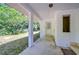 This home has a covered area with classic white pillars leading to a door and a lovely green space at 13329 N Armenia Ave, Tampa, FL 33613