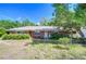 Traditional brick home with well-maintained landscaping, offering a classic and inviting appearance at 13329 N Armenia Ave, Tampa, FL 33613