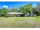 Charming brick home featuring a well-manicured lawn and lush greenery in a serene setting at 13329 N Armenia Ave, Tampa, FL 33613