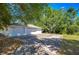 Detached three-car garage boasts durable white siding, concrete driveway, and ample parking space at 13329 N Armenia Ave, Tampa, FL 33613
