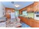 Functional kitchen with wooden cabinetry and a breakfast nook, blending style and practicality at 13329 N Armenia Ave, Tampa, FL 33613