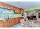 Well-lit kitchen featuring wooden cabinets and an open design, perfect for cooking and entertaining at 13329 N Armenia Ave, Tampa, FL 33613