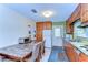 Traditional eat-in kitchen features wooden cabinets and access to backyard at 13329 N Armenia Ave, Tampa, FL 33613