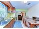 Charming kitchen with wooden cabinets, seamlessly connecting to the cozy living area for easy interaction at 13329 N Armenia Ave, Tampa, FL 33613