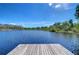 A tranquil lake view from a wooden dock, perfect for relaxation and enjoying nature at 13329 N Armenia Ave, Tampa, FL 33613