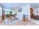 Spacious living room with hardwood floors, a white sofa, and an open view to a dining area at 13329 N Armenia Ave, Tampa, FL 33613