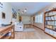 Inviting living room with a white sofa, modern lighting, and a full bookshelf, creating a cozy space at 13329 N Armenia Ave, Tampa, FL 33613