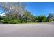 Street view of a home surrounded by lush greenery, showcasing its curb appeal at 13329 N Armenia Ave, Tampa, FL 33613