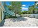 This home features a backyard with a stone patio, a privacy fence, and tropical landscaping at 136 30Th N Ave, St Petersburg, FL 33704