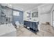Bathroom featuring dual vanity with blue cabinets, and a glass shower enclosure with blue tiled walls at 136 30Th N Ave, St Petersburg, FL 33704
