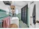 Bathroom features a shower with turquoise tile and patterned shower curtain at 136 30Th N Ave, St Petersburg, FL 33704