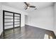 Bedroom featuring sliding closet doors, a ceiling fan and wood-look flooring at 136 30Th N Ave, St Petersburg, FL 33704