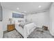 Cozy bedroom with white walls, a patterned rug, and a sliding barn door at 136 30Th N Ave, St Petersburg, FL 33704