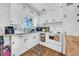 Bright kitchen featuring white cabinets, granite countertops, stainless appliances, and hardwood floors at 136 30Th N Ave, St Petersburg, FL 33704