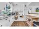 Bright kitchen featuring white cabinets, granite countertops, stainless appliances, and hardwood floors at 136 30Th N Ave, St Petersburg, FL 33704