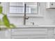 Modern kitchen sink with stainless steel faucet and white subway tile backsplash at 136 30Th N Ave, St Petersburg, FL 33704