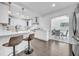 Modern kitchen with white cabinets, stainless steel appliances, and a breakfast bar with seating at 136 30Th N Ave, St Petersburg, FL 33704
