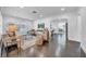 Bright living room with hardwood floors, neutral furniture, and an open doorway to the kitchen at 136 30Th N Ave, St Petersburg, FL 33704