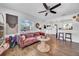 Inviting living room showcasing a pink sofa, wood flooring, and easy access to the kitchen at 136 30Th N Ave, St Petersburg, FL 33704