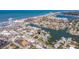 Wide aerial perspective of a canal-front neighborhood, with beautiful ocean views and community amenities at 145 174Th Terrace E Dr, Redington Shores, FL 33708