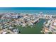 Aerial view showcasing a waterfront community with canals, docks, and stunning ocean views, offering a coastal lifestyle at 145 174Th Terrace E Dr, Redington Shores, FL 33708