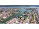 Panoramic aerial view of a beautiful waterfront community with access to canals, docks, and open bay waters at 145 174Th Terrace E Dr, Redington Shores, FL 33708