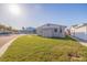 View of the side of the house with a large grassy yard and storage shed at 145 174Th Terrace E Dr, Redington Shores, FL 33708