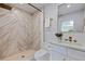 Updated bathroom featuring walk-in shower, modern fixtures, and decorative tile design at 145 174Th Terrace E Dr, Redington Shores, FL 33708