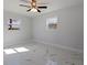 Bedroom with two windows and a ceiling fan at 145 174Th Terrace E Dr, Redington Shores, FL 33708