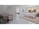 Bright bedroom showing chair, bedside table, view to living room and large window at 145 174Th Terrace E Dr, Redington Shores, FL 33708