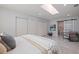 Bright bedroom boasts a skylight, closet, bathroom access, and sleek modern flooring at 145 174Th Terrace E Dr, Redington Shores, FL 33708