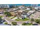 Charming single-story home featuring a manicured lawn, paved driveway, and mature landscaping in a desirable beachside community at 145 174Th Terrace E Dr, Redington Shores, FL 33708